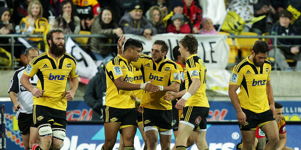 Julian Savea of the Hurricanes is congratulated on his try by teammates Andre Taylor and Beauden Barrett during the Super Rugby round 18 game. Photo / Getty images.