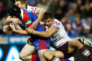 Joel Edwards of the Knights is tackled by Anthony Watmough of the Sea Eagles. Photo / Getty Images.