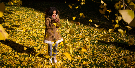 Lequire Makai from Kawerau makes the most of a fine winter day during the school holidays on a stroll through golden leaves in the Auckland Domain. Photo / Greg Bowker