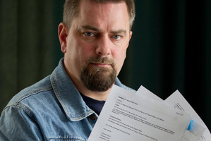 Kahl Sharpe, who injured his neck and shoulder in 2008 when he was lifting a child onto a top bunk, shows documents which included the case notes relating to another person. Photo / Richard Robinson