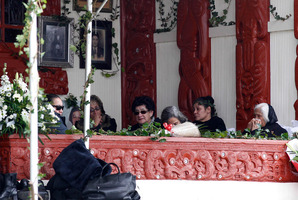 Relatives and kuia keep watch over the coffin on the porch of the meeting house at Waihi Marae near Turangi. Picture / Christine Cornege