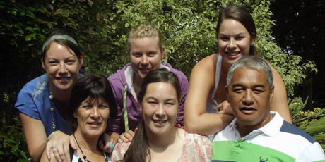 Linda Villumsen (middle back) with the Houkamau family, Tara-Lee (left), mum Angela, Tyneesha, Tessa and dad Bindy. Photo / Supplied