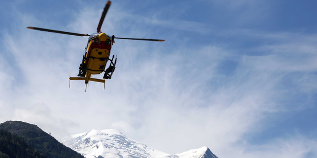 A rescue worker helicopter returning from the avalanche site, lands in Chamonix, French Alps, after a deadly slide killed nine. Photo / AP