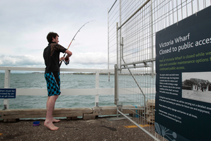 A fisherman on Victoria Wharf. Photo / Richard Robinson