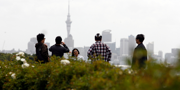 Touirists take in the sites of Auckland. New Tourism Industry Assn head Martin Snedden says the NZ tourism industry needs to adapt to different expectations of visitors from Asia. Photo / Dean Purcell