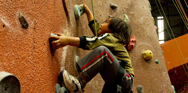 Tapu, 6, scales the wall at Extreme Edge. Photo / Kellie Blizard