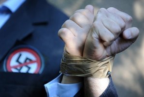 Activists of the European Union of Jewish Students stand with their hands taped to each other's in front of Laszlo Csatary's hideaway building. Photo / AFP