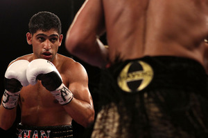 WBC champ Danny Garcia added the WBA light welterweight belt to his collection with a stunning fourth-round upset of Britain's Amir Khan in a unification title fight today. Photo / Getty Images.