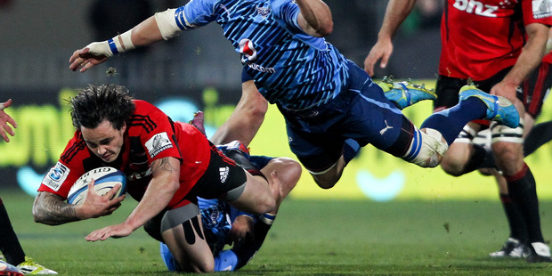 Zac Guildford is lowered in the tackle of Jacques Potgieter of the Bulls. Photo / Getty Images