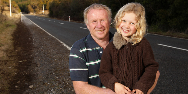 Kevin O'Brien and Michelle, 8, outside their farm gate on State Highway 46 near Rangipo. Photo / Alan Gibson