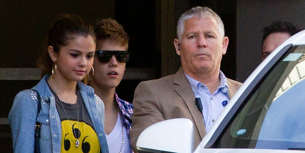 Justin Bieber, with girlfriend, singer Selena Gomez (left), leaves the Langham Hotel from a secret exit avoiding hundreds of young fans today. Photo / Greg Bowker