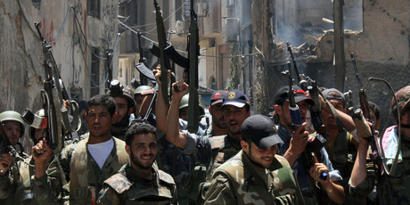 Syrian soldiers celebrate after they regained control of Midan, in the southern part of Damascus. Photo / AP