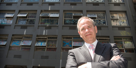 Mayor Len Brown outside the Yates building before the graffiti magnet was cleaned up by council for the Rugby World Cup. Photo / Greg Bowker