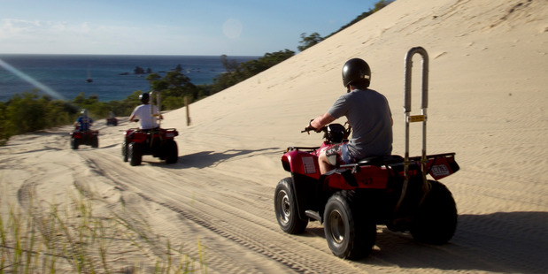 Quad biking is part of the action on a desert safari at Tangalooma Island. Photo / Kellie Blizard