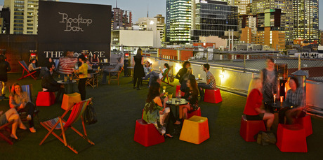 People enjoy drinks at the Rooftop Bar & Cinema at Curtin House, Melbourne. Photo / Supplied