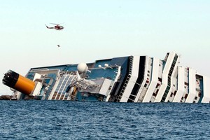 The luxury cruise ship Costa Concordia leans on its side after running aground off the tiny Tuscan island of Giglio, Italy. Photo / AP
