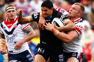 Brad Tighe of the Panthers is tackled by Martin Kennedy (2nd R) of the Roosters during the round 20 NRL match. Photo / Getty Images.