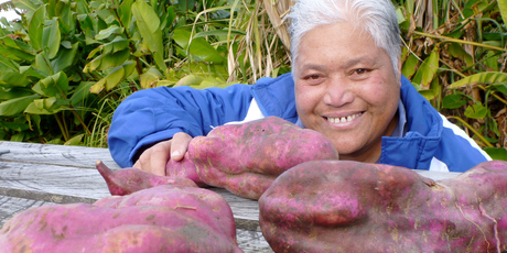 Teina Tangimetua with some of her brother's giant kumara harvest. Photo / Meg Liptrot
