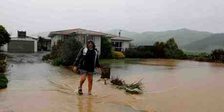 Des Hunt walks down the driveway on his Thorp Rd property outside Paeroa during heavy rains today. Photo / Christine Cornege