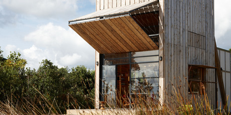 Ken Crosson's 'hut on sleds', a 40sq m bach on the Coromandel Peninsula that can be shifted around its beach-front section. Photo / Supplied
