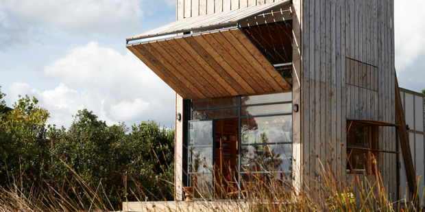 Ken Crosson's 'hut on sleds', a 40sq m bach on the Coromandel Peninsula that can be shifted around its beach-front section. Photo / Supplied