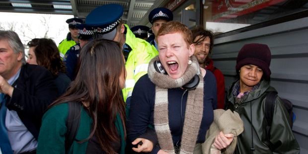 Police remove people protesting at a meeting between Auckland Mayor Len Brown and Housing Minister Phil Heatley at Tamaki College yesterday.Photo / Sarah Ivey