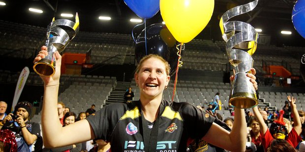 Casey Williams holds the trophies aloft at a parade in Hamilton. Photo / Christine Cornege.