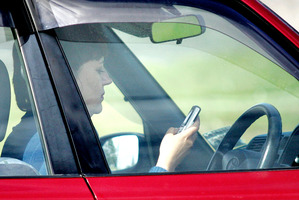 Drivers snapped using mobile phones. Photo / Doug Sherring