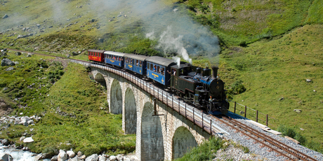 A steam locomotive negotiates the Steinstafelviadukt on the picturesque Dampfbahn Furka-Bergstrecke in Switzerland. Photo / Creative Commons image by Wikimedia user David Gubler