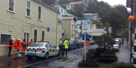 Police at the scene in Devon Street in Wellington, where a digger has rolled and killed a man. Photo / APNZ