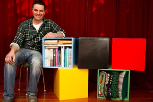 Justin Newcombe and his storage cubes painted in Olympic colours. Photo / Steven McNicholl