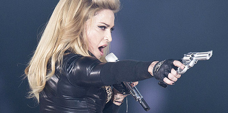 Madonna brandishes a fake gun during an earlier show on her MDNA world tour. Photo / AP Madonna brandishes a fake gun during an earlier show on her MDNA world tour. Photo / AP