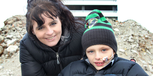 Justine and Jayden Halliwell will implode the earthquake-damaged Radio Network House behind them on Sunday. Photo / APN