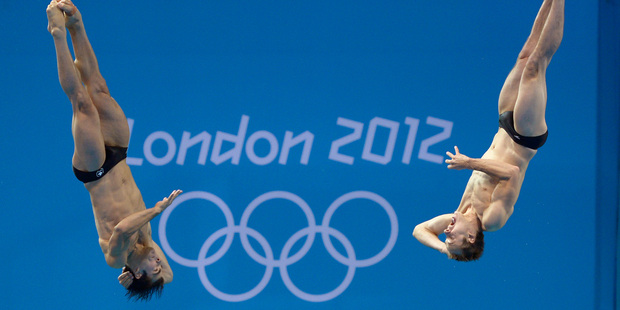 Alexandre Despatie, left, and Ross Reuben of Canada compete during the men's synchronized 3-meter springboard diving final. Photo / AP.