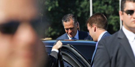 Republican presidential candidate Mitt Romney gets in his vehicle as reporters shout questions at him in Poland. A comment from his aide has capped a horror gaffe week. Photo / AP