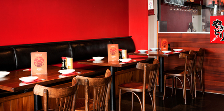 Red walls and plain wooden furniture grace Japanese restaurant Taisho. Photo / Babiche Martens