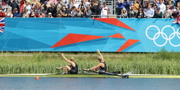 Eric Murray and Hamish Bond wave to New Zealand supporters after their medal ceremony. Photo / Brett Phibbs