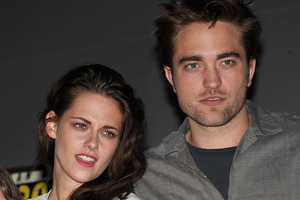 Robert Pattinson is reportedly recovering from Kristen Stewart's betrayal by chatting to strangers in his hotel and playing computer games. Photo / AP