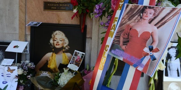 Pictures, flowers, letters and other memoriablia left by fans surround the crypt of Hollywood legend Marilyn Monroe before a memorial service to mark the 50th anniversary at her death. Photo / AFP