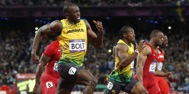Jamaica's Usain Bolt blitzes the field on his way to taking the gold medal in the Olympic Games 100m final at Olympic Stadium Olympic in London. New Zealand Herald Photograph by Mark Mitchell.