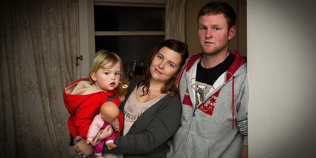 Kim and Isaac Allison with 2-year-old Alice, say their home is cold and damp.
Photo / Martin Hunter