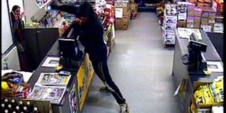 The robber menaces shop assistant Chandan Gosai. The offender was unable to open the till and fled. Photo / Supplied