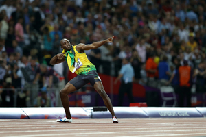 Usain Bolt celebrates winning the 200m final, the first sprinter to win both the 100m and 200m races at two consecutive games.Picture / AP
