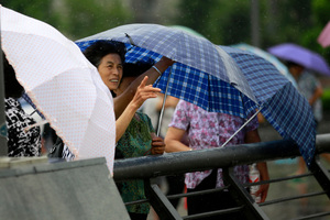 Tourists braved winds last week as typhoon Saola approached the city of Shanghai, China. Photo / AP