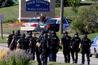 Police walk near the Sikh Temple of Wisconsin in Oak Creek. Photo / AP
