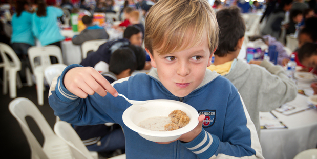 Ethan Hope, 10, from Gladstone Primary School in Auckland, tucks in as part of a record breakfast-eating attempt yesterday. Photo / Greg Bowker