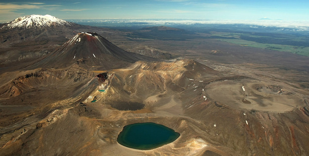 The starkly beautiful Central Plateau with the Blue Lake of Mt Tongariro (front), Mt Ngauruhoe and snow-capped Mt Ruapehu. Photo / File