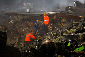 Emergency services search the rumble for survivors of the collapsed CTV building after the earthquake. Photo / Brett Phibbs