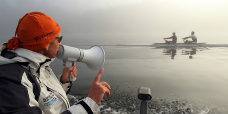 Legendary rowing coach Dick Tonks works the megaphone on a misty morning at Lake Karapiro. Picture / Janna Dixon