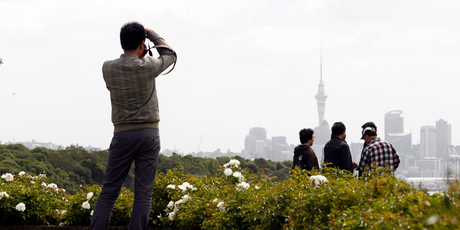 Asian tourists take in the sites of Auckland City from Bastion Point. Photo / Dean Purcell